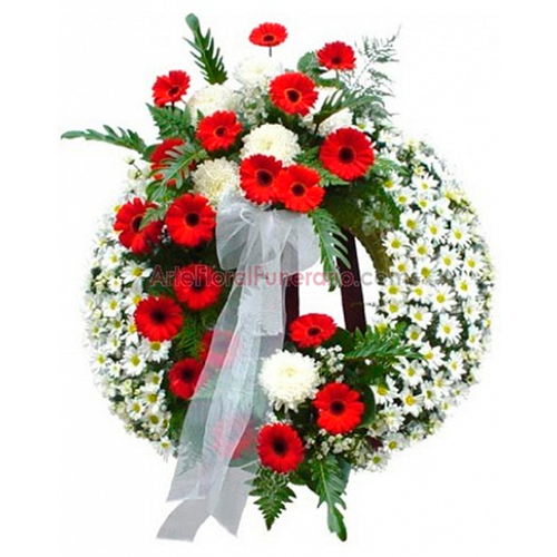 Corona fúnebre de gerberas rojas, margaritas y pompones blancos